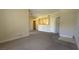 Open-concept living room with neutral walls and carpeting, showcasing layout and flow at 8000 W Badura Ave # 1019, Las Vegas, NV 89113