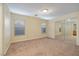 Spacious bedroom with neutral carpet and closet with mirrored sliding doors and natural light at 8234 Misty Sage St, Las Vegas, NV 89139