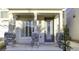 Close-up of front porch features stone columns, shuttered window, and decorative glass front door at 8234 Misty Sage St, Las Vegas, NV 89139