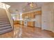 Open concept kitchen and staircase with hardwood floors and stainless-steel appliances at 8234 Misty Sage St, Las Vegas, NV 89139