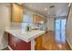 Bright kitchen featuring wood cabinets, white tile countertops, and modern appliances at 8234 Misty Sage St, Las Vegas, NV 89139