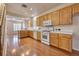 Spacious kitchen featuring wood cabinets and white appliances at 8234 Misty Sage St, Las Vegas, NV 89139