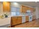 Well-lit kitchen with wooden cabinetry and modern white appliances at 8234 Misty Sage St, Las Vegas, NV 89139