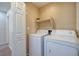 Laundry room features a newer washer and dryer and built in shelving at 8234 Misty Sage St, Las Vegas, NV 89139