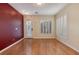 Bright living room features wood floors, white plantation shutters, a glass-paneled door, and accent wall at 8234 Misty Sage St, Las Vegas, NV 89139