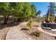 Serene backyard with lush greenery, a stone walkway, and comfortable seating, providing a private outdoor retreat at 8262 Huxley St, Las Vegas, NV 89123