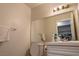 Bathroom with white vanity, toilet, large mirror and modern lighting at 8262 Huxley St, Las Vegas, NV 89123