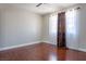 Bright bedroom with wood floors, three windows and patterned curtains provide light at 8262 Huxley St, Las Vegas, NV 89123