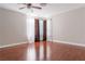 Neutral bedroom with dark wood floors, a ceiling fan, and bright natural light at 8262 Huxley St, Las Vegas, NV 89123