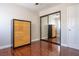 Wood-floored bedroom with dresser and mirrored closet door at 8262 Huxley St, Las Vegas, NV 89123