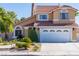 Charming two-story home with a well-maintained lawn and garden, showcasing its appealing curb appeal at 8262 Huxley St, Las Vegas, NV 89123