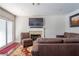 Cozy living room featuring a fireplace, comfortable seating, and sliding glass doors leading to the outdoor space at 8262 Huxley St, Las Vegas, NV 89123