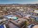 Aerial shot of a home with a pool and desert landscaping, set against a backdrop of commercial areas and city infrastructure at 8645 Edmond St, Las Vegas, NV 89139