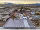 Wide-angle view of a home with a desert landscape, complemented by mountain views and neighboring residential properties at 8645 Edmond St, Las Vegas, NV 89139