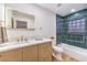 Modern bathroom featuring stylish vanity, contemporary fixtures, and tile accents in shower at 8645 Edmond St, Las Vegas, NV 89139