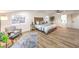 Inviting bedroom featuring a cozy seating area, modern ceiling fan, and abundant natural light at 8645 Edmond St, Las Vegas, NV 89139