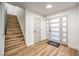 Bright entryway features wood flooring, a staircase, and a modern front door at 8645 Edmond St, Las Vegas, NV 89139