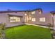 Exterior view of a stucco home with a well manicured lawn and arched entry at 8645 Edmond St, Las Vegas, NV 89139