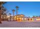 Charming two-story stucco home featuring manicured landscape, an arched entrance, and a three-car garage at 8645 Edmond St, Las Vegas, NV 89139