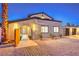 Stucco home featuring an arched gated entry, a well-manicured walkway, and a modern three-car garage at 8645 Edmond St, Las Vegas, NV 89139