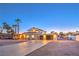 Stucco home with modern three-car garage, complemented by landscaped yard, arched entry, and contemporary design at 8645 Edmond St, Las Vegas, NV 89139