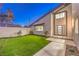 Exterior view of a stucco home featuring a well manicured lawn and modern entry door at 8645 Edmond St, Las Vegas, NV 89139