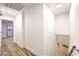 Bright hallway features modern wood floors, white walls, leading to carpeted living space and staircase at 8645 Edmond St, Las Vegas, NV 89139