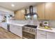 Modern kitchen showcases stainless steel oven, range hood, bright countertops, and light wood cabinets at 8645 Edmond St, Las Vegas, NV 89139