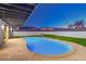 Backyard pool with lounge chairs and artificial grass at 8645 Edmond St, Las Vegas, NV 89139