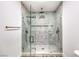 Luxurious walk-in shower with dual showerheads, designer tile work, and a frameless glass enclosure at 8645 Edmond St, Las Vegas, NV 89139