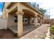 Spacious covered patio in backyard with arched pillars and low maintenance landscaping at 8699 Grand Sequoia St, Las Vegas, NV 89139