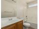 Bright bathroom featuring a single sink vanity, toilet, and bathtub with shower at 8699 Grand Sequoia St, Las Vegas, NV 89139