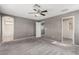 Carpeted bedroom with views of a bathroom and hallway at 8699 Grand Sequoia St, Las Vegas, NV 89139