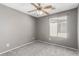 Bedroom with a ceiling fan, carpet flooring, and natural light from the window at 8699 Grand Sequoia St, Las Vegas, NV 89139