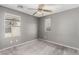 Carpeted bedroom with grey walls, a ceiling fan and natural light from windows at 8699 Grand Sequoia St, Las Vegas, NV 89139