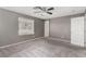 Bedroom with a ceiling fan, carpet flooring, and natural light from the window at 8699 Grand Sequoia St, Las Vegas, NV 89139