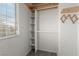 Walk-in closet featuring built-in shelving, wooden accents and a window for natural light at 8699 Grand Sequoia St, Las Vegas, NV 89139