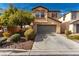 Charming two-story home with two car garage, desert landscaping and a concrete driveway at 8699 Grand Sequoia St, Las Vegas, NV 89139