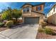 Charming two-story home with two car garage, desert landscaping and a concrete driveway at 8699 Grand Sequoia St, Las Vegas, NV 89139