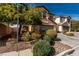 Charming two-story home with two car garage, desert landscaping and a concrete driveway at 8699 Grand Sequoia St, Las Vegas, NV 89139