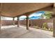 Undercover back patio area with arched supports, brick perimeter and blue sky overhead at 8699 Grand Sequoia St, Las Vegas, NV 89139