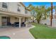 Backyard patio includes an outdoor kitchen, seating, and overlooks a well-manicured yard and pool at 8800 Las Olivas Ave, Las Vegas, NV 89147