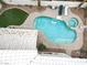 Backyard with a Kidney-shaped pool and hot tub, with tables and chairs for entertaining at 8800 Las Olivas Ave, Las Vegas, NV 89147