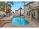 Private backyard pool with water feature surrounded by well-maintained landscaping and patio furniture at 8800 Las Olivas Ave, Las Vegas, NV 89147