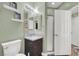 Bathroom featuring a single sink vanity, a large mirror and glass enclosed shower at 8800 Las Olivas Ave, Las Vegas, NV 89147