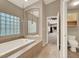 Bathroom showing the tub, toilet and doorway to the bedroom at 8800 Las Olivas Ave, Las Vegas, NV 89147