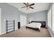 This bedroom features light blue walls, a ceiling fan, carpeted floors and a large bed with nightstands at 8800 Las Olivas Ave, Las Vegas, NV 89147