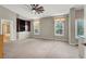 Spacious carpeted main bedroom featuring a ceiling fan and built in bookcase at 8800 Las Olivas Ave, Las Vegas, NV 89147