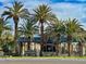 Granada Hills community entrance featuring lush palm trees against a clear blue sky at 8800 Las Olivas Ave, Las Vegas, NV 89147