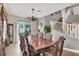 Elegant dining room features a large table, wooden floors, and staircase with white railing at 8800 Las Olivas Ave, Las Vegas, NV 89147